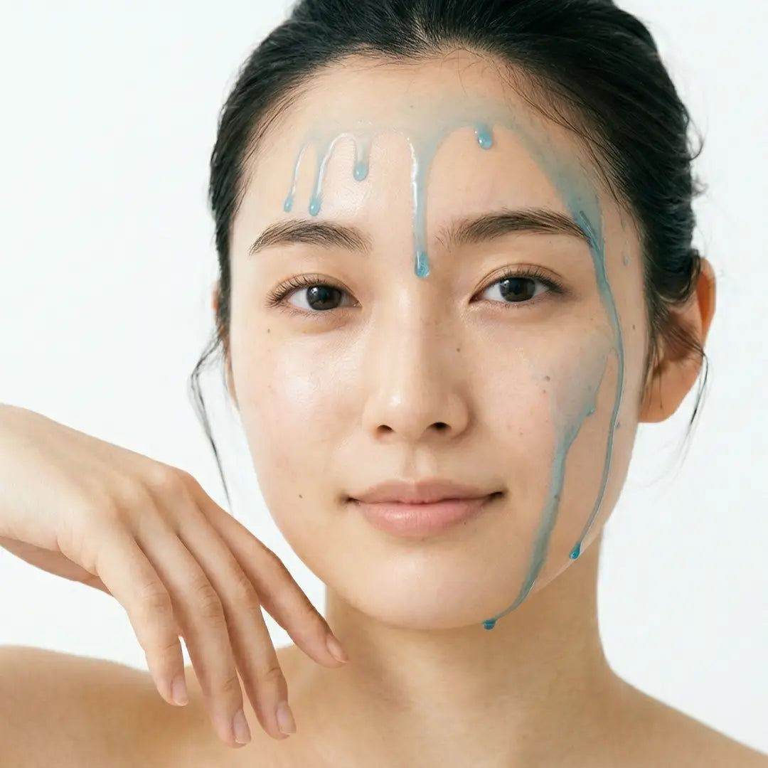 Woman with blue BY VALENTI Olio di C Vitamin C lipid-serum dripping on her face against a white background