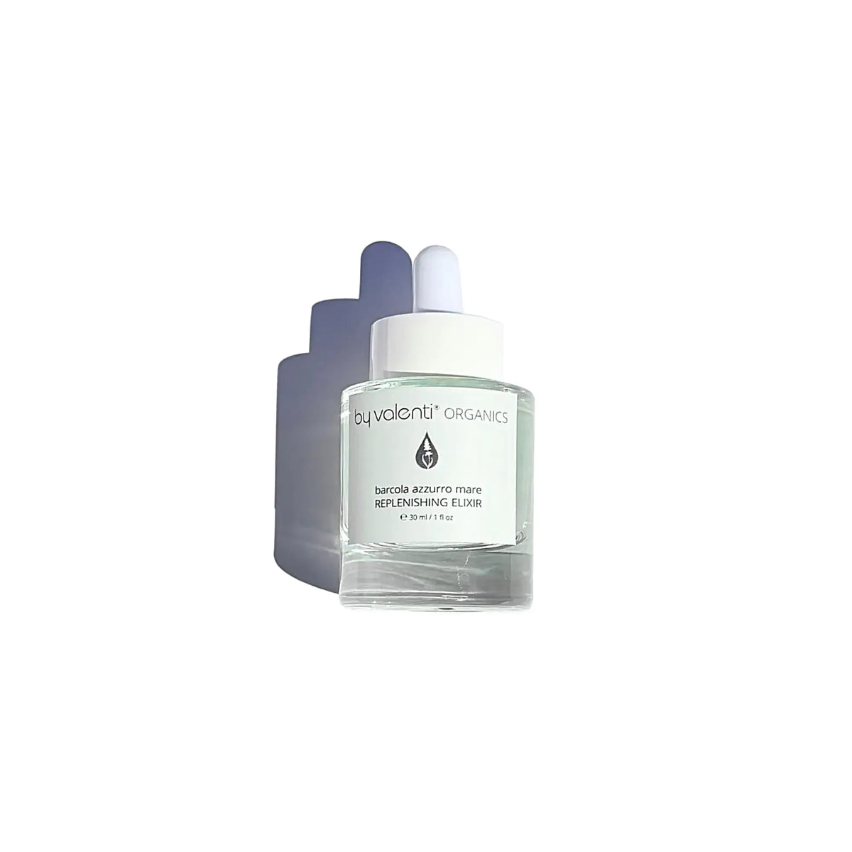 A clear glass dropper bottle of by valenti Organics Replenishing Elixir with a white label and white dropper cap, set against a light gray background with a soft shadow.