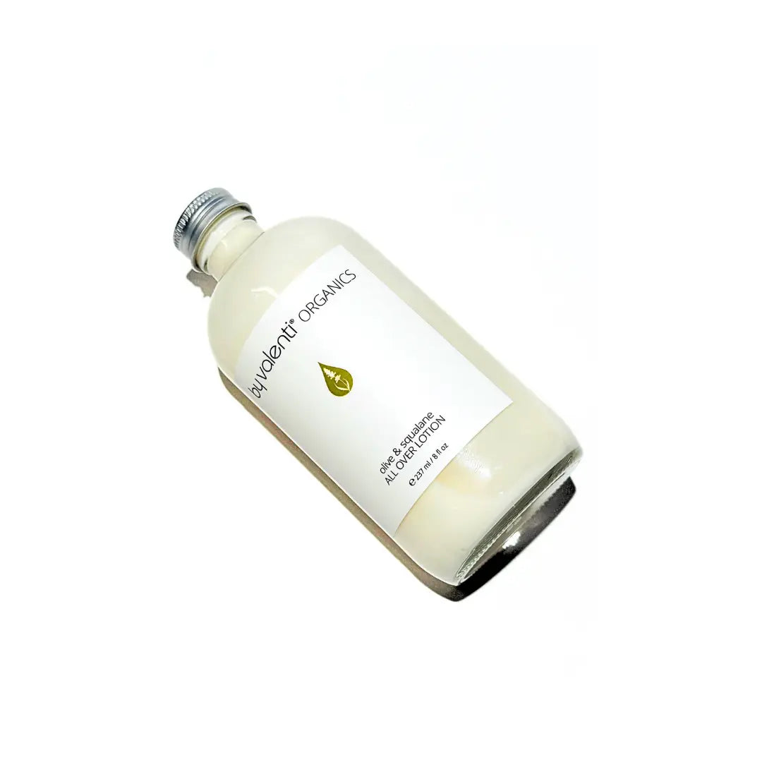 Bottle of BY VALENTI Olive & Squalane unscented all over lotion for hands, body and hair on a white background