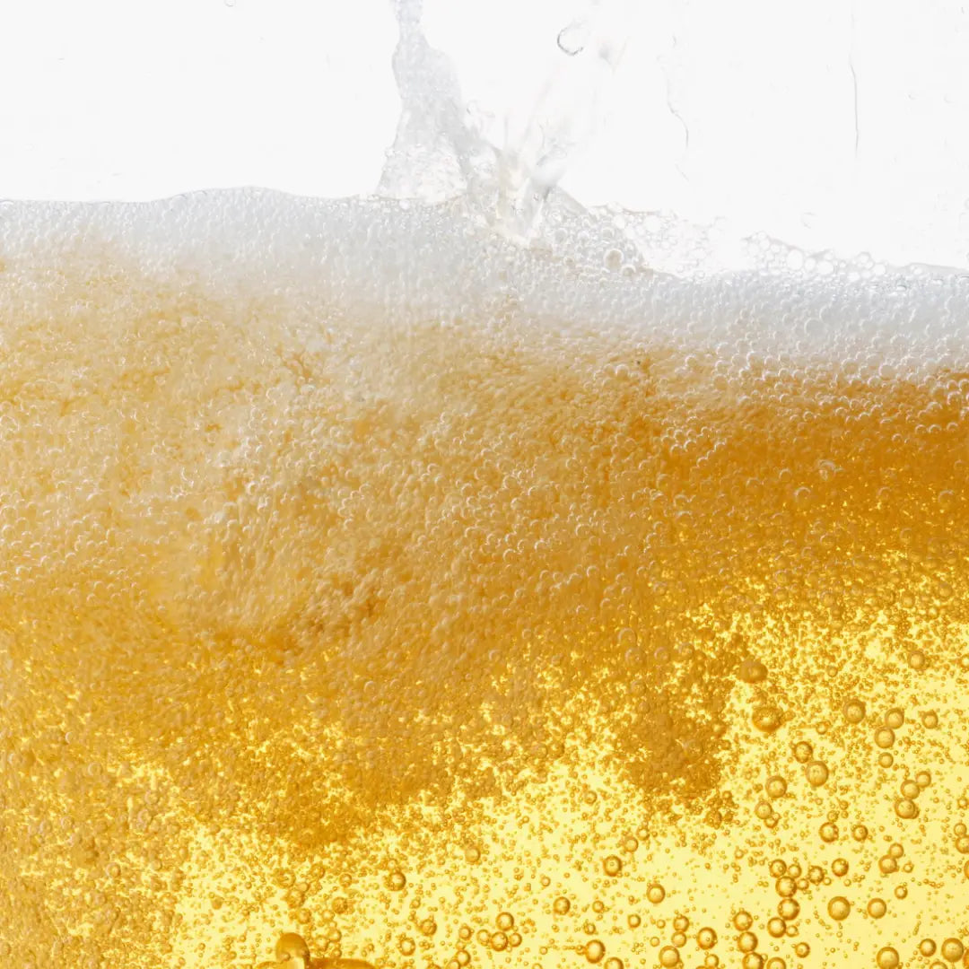 Close-up of liquid soap with foam and bubbles on a white background
