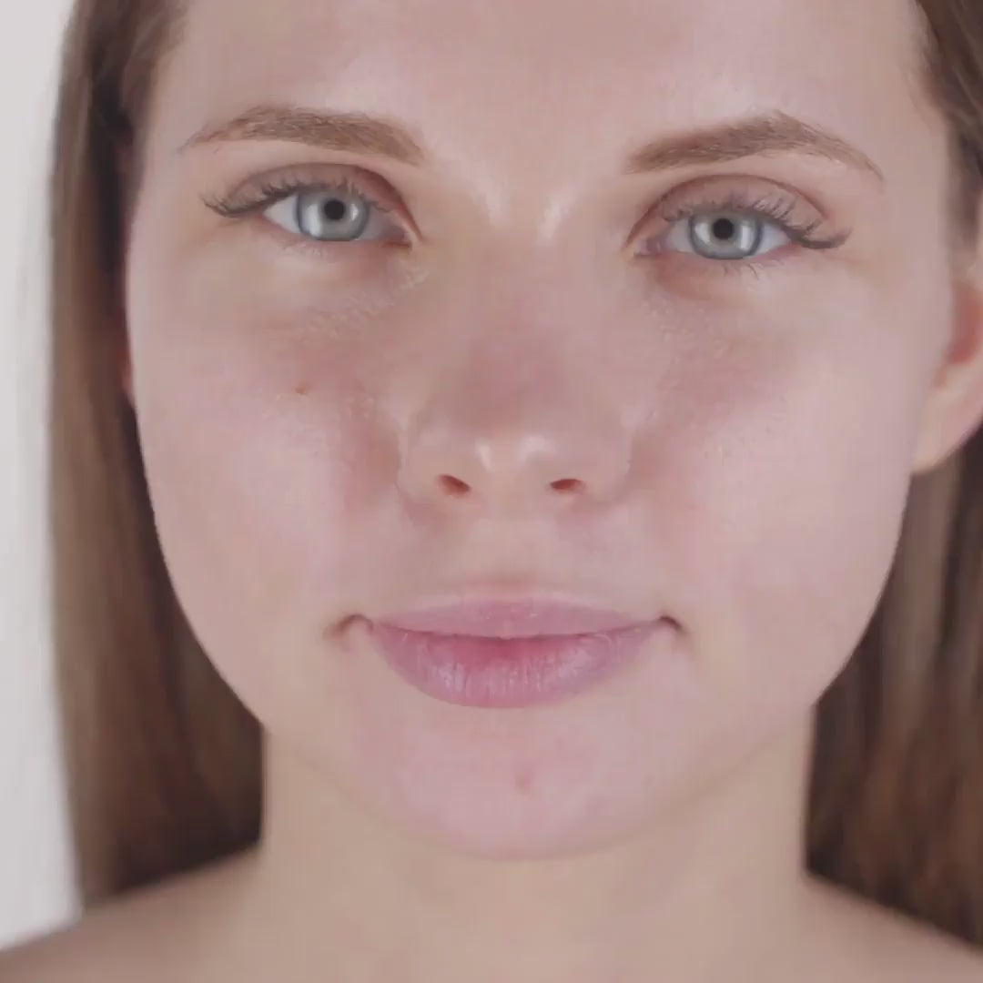 Woman applying By Valenti antiaging lotion on face