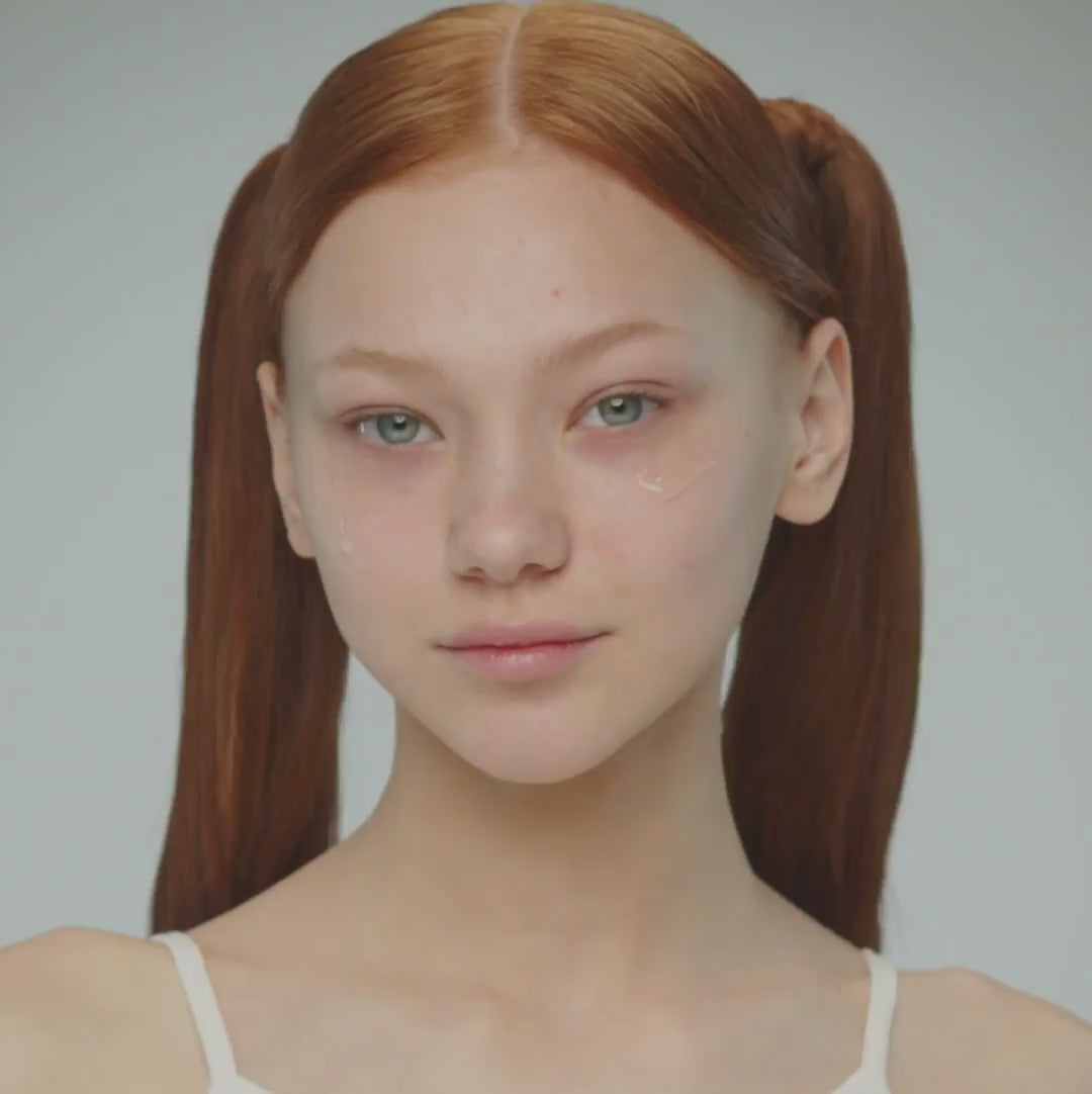Video of young woman with red hair in two pony tails and blue eyes, applying By Valenti Aqua B3 10% niacinamide serum on her face, showcasing clear clean skin.