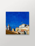 Manuela Valenti Studio & Gallery painting of rooftops with chimneys against a blue sky